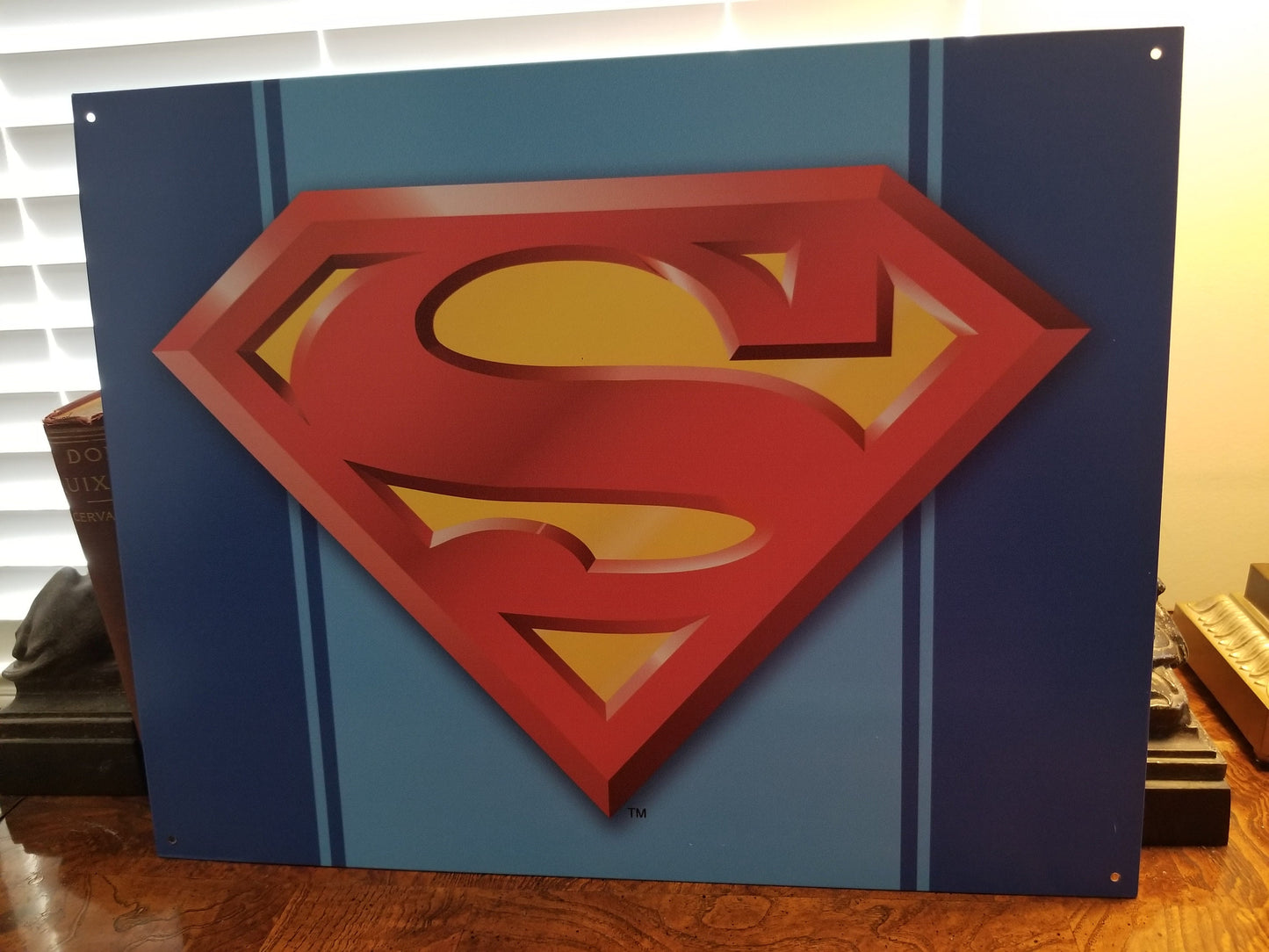 Superman,The Man of Steel Logo.This Design Is On A 16 W x 12.5 H Tin Sign.This Quality Sign Has A Smooth Clear Coat Finish.