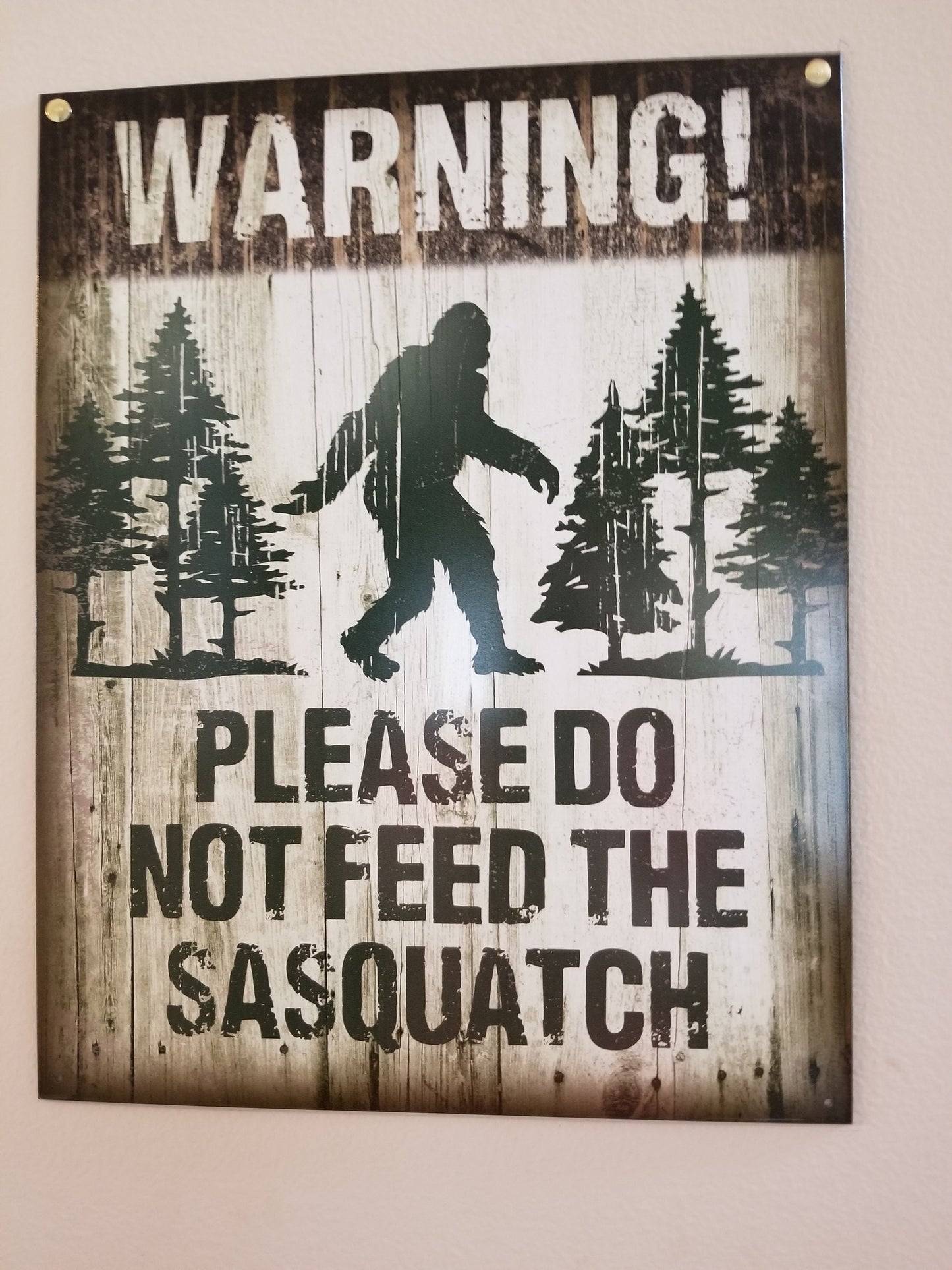 Please Do Not Feed The Sasquatch,This Design Is On A 12.5” W x 16” H Tin Sign.This Quality Sign Has A Smooth Clear Coat Finish