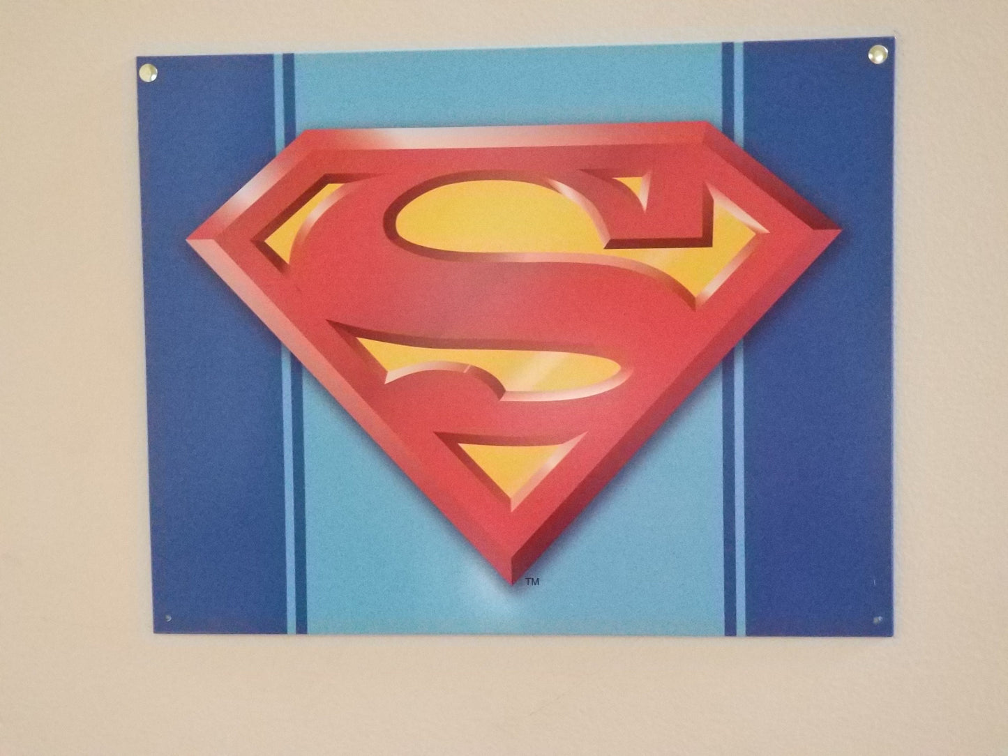 Superman,The Man of Steel Logo.This Design Is On A 16 W x 12.5 H Tin Sign.This Quality Sign Has A Smooth Clear Coat Finish.