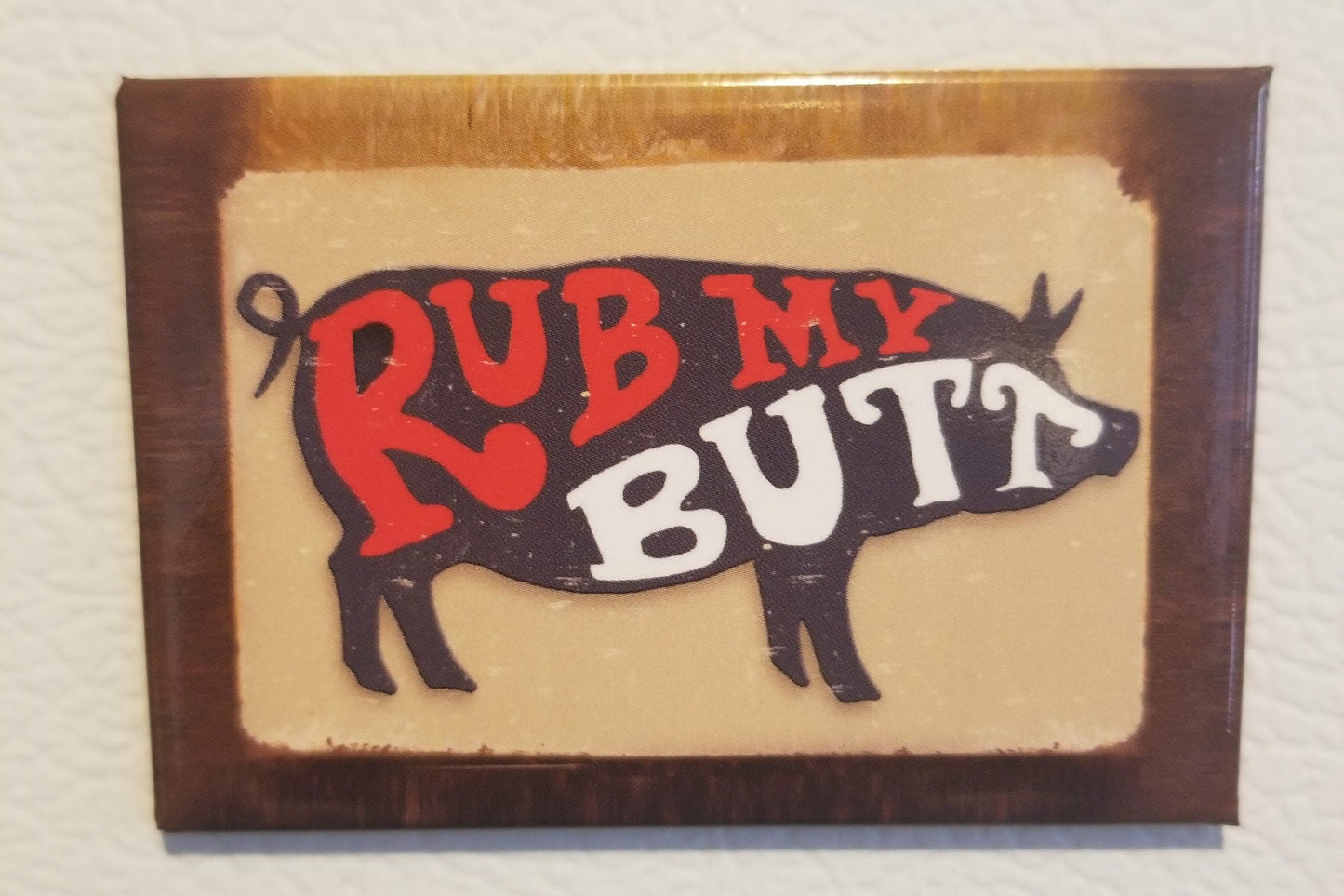 Rub My Butt on a 2x3 Refrigerator Magnet with Glossy Finish. Steel construction with strong magnet holding power. Gift For Him or Her.A