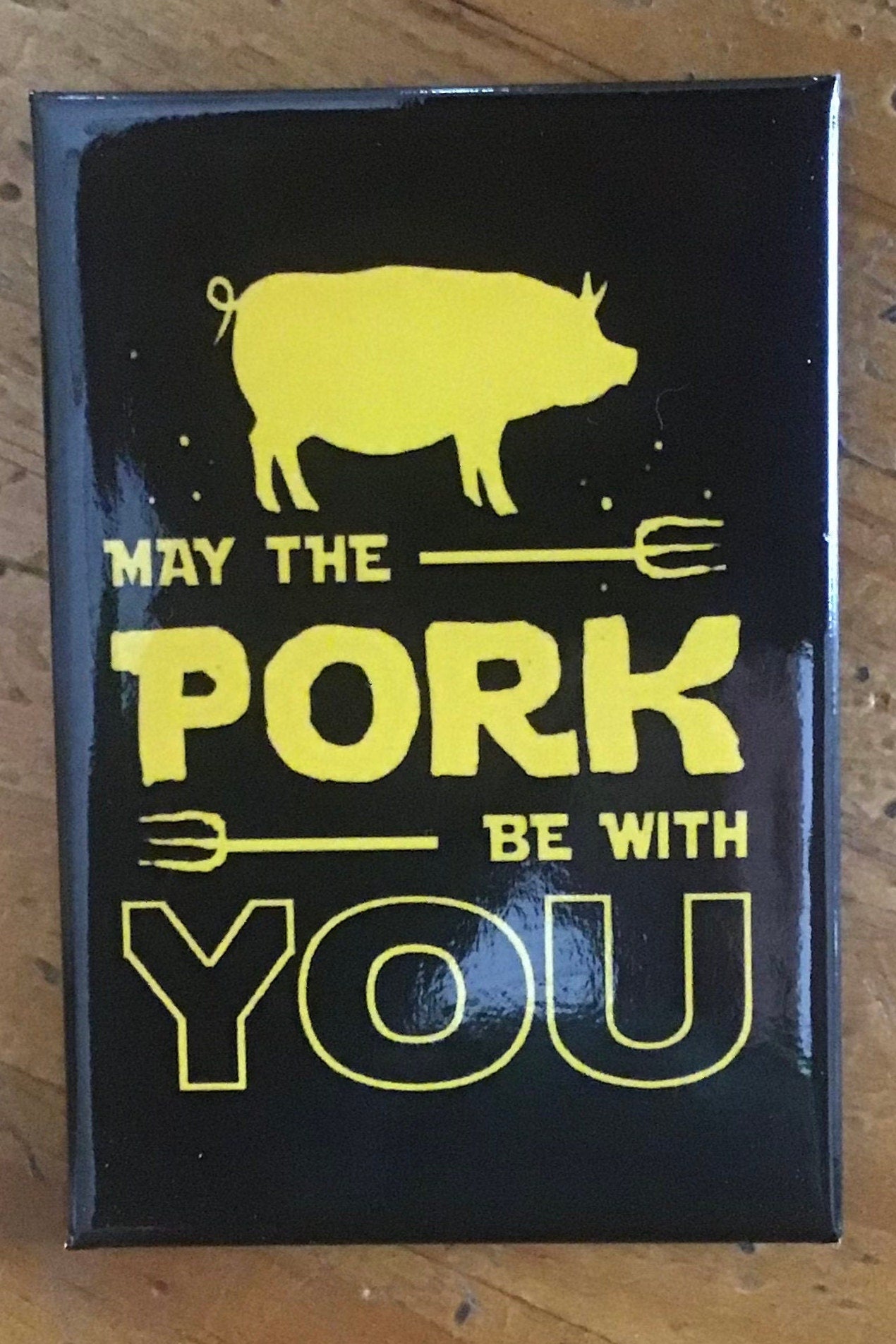 May The Pork Be With You on a 2x3 Magnet with Glossy Finish and Metal Construction. A Gift For Him or Her.